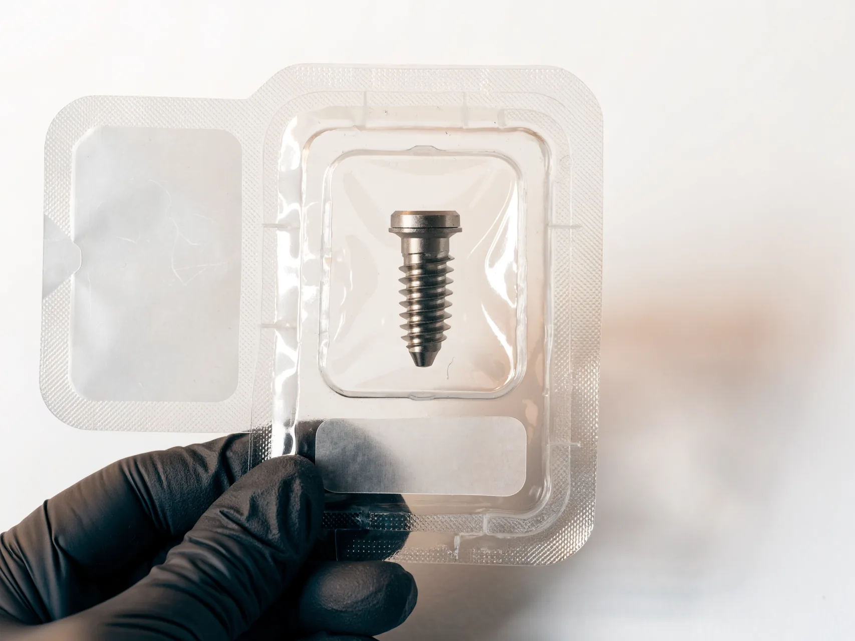 Titanium implant fixture still sealed in its sterile blister pack
