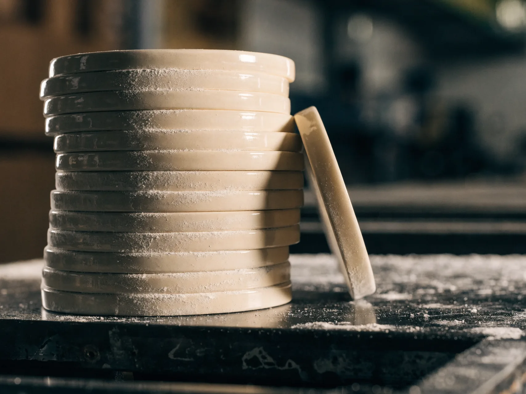 Pre-shaded zirconia milling discs stacked on a laboratory bench